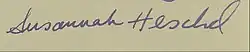 Zu sehen ist hier die Unterschrift von Susannah Heschel. Der Nachname ist größer und geschwungener als der Vorname. Das Papier ist beige-farben und die Unterschrift mit blauer Tinte geschrieben.