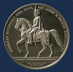 Silberne Medaille auf das Reiterstandbild „zur Erinnerung an die Feier der Enthüllung“ am 21. September 1861, dem 10. Todestag des Monarchen, unter seinem Sohn und Nachfolger König Georg V.; Medailleur Friedrich Brehmer; Münzkabinett des Niedersächsischen Landesmuseums Hannover