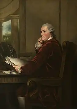 Gemälde des Duke of Portland, der dem Stil der Zeit entsprechend eine gepuderte weiße Perücke sowie einen weinroten Samtanzug und weiße Strümpfe trägt. Er sitzt auf einem geschnitzten, verzierten Stuhl, sein Blick geht nach links, er sieht nachdenklich aus. Vor ihm ein Schreibtisch, auf dem sein linker Arm ruht, in der Hand hat er einige Unterlagen, auf dem Schreibtisch sind ebenfalls zahlreiche Unterlagen verteilt. Dahinter sind auf dem Schreibtisch verteilt auch einige Bücher sowie eine Skulptur. Seine rechte Hand stützt sein Kinn.