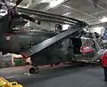 Ein BHS Sea King im Hangar. Unter dem Hinterrad ist die Verfahranlage sichtbar, die Rotorblätter sind gefaltet.