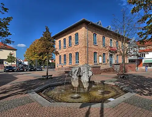 Altes Rathaus Mörfelden von 1876. Davor: Brunnen „Erzählstein“