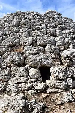 Die Ostseite des Talayots mit einer Öffnung (linkes Bild), die auf eine Treppe im Inneren führt (rechtes Bild).