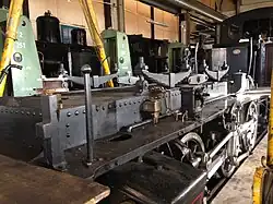 Dampflokomotive vom Typ Tigerli der Dampfbahn Bern mit abgehobenem Kessel. Gut sichtbar ist nun der Wasserkasten, der zwischen die Antriebsachsen hinab reicht.