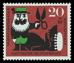 Der Jäger befreit die Großmutter und Rotkäppchen aus dem Bauch des Wolfs.