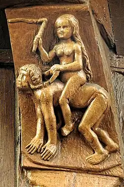 Nackter Mann erliegt den Reizen einer peitschen­schwingenden Frau