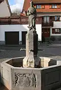 Brunnen mit Denkmal für Pfarrer Clemens Langenhof