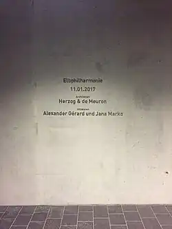 Abbildung der Plakette im Eingang der Elbphilharmonie Hamburg mit der Widmung der Architekten Herzog & de Meuron sowie der Initiatoren Alexander Gérard und Jana Marko