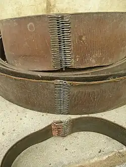 Riemenschloss-Krallen wurden gebündelt auf Papierstreifen ausgeliefert, bevor sie zum Einsatz kamen (unten: Krallen noch im Papierstreifen)