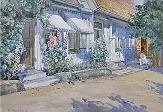 Straße mit Strickerin und Stockrosen