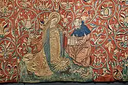 Geburt Christi nach der Vision der Birgitta von Schweden. Szene aus dem Marienteppich, Mittelrhein um 1500/1510, Domschatz Halberstadt. Das Christuskind im Strahlenkranz auf dem Boden, daneben die kniende Maria und Joseph mit einer Laterne. Im Hintergrund Ochs und Esel. Vorne Hund, Einhorn und Kaninchen.