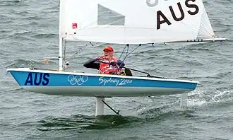 Segelboot, Typ Laser-Jolle mit Tragflächen.