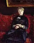 Gustave Caillebotte: Frau, die auf einem rot-geblümten Sofa sitzt, 1882.