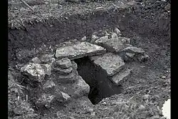 Schrägansicht auf einen Schnitt, die intakten Deckplatten liegen hier nur ca. 0,5&nbsp;m unter der damaligen Oberfläche, der Leitungsquerschnitt ist verschlammt.