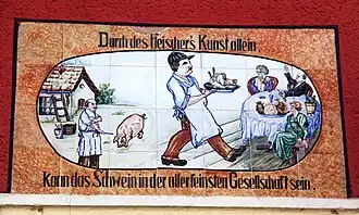 Keramisches Wandbild an einer ehemaligen Fleischerei an der Ossietzkystraße