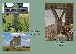 Ortseinfahrtsschild von Dunlop und Vorfahrtgewährenzeichen der Firma Japy