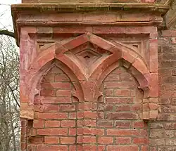 Baudetail mit geformten Backsteinen unterhalb des Eckturms