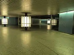 Blick in eine sich verzweigende Unterführung mit runden Leuchtsäulen