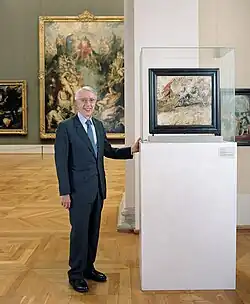 Heribald Närger in der Alten Pinakothek in München neben einer Skizze zu Peter Paul Rubens Gemälde „Die Löwenjagd“.