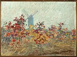 Ein impressionistisches Ölgemälde der Malerin Jenny Montigny von 1913. In stark pastoser Malweise zeigt sie im Vordergrund einige durch schnelle Pinselstriche dargestellte Bäume mit roten Blättern auf einem erdigen Untergrund. Im Hintergrund hebt sich gegen den wolkenlosen Himmel die Silhouette einer Windmühle, die sogenannten „Deurlemolen“, ab.