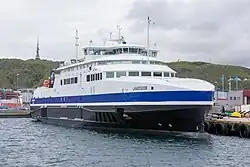 Foto einer Fähre mit weiß-blau-schwarzem Anstrich im Hafen von Bodø