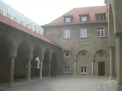 Arkadenhof, links: Arkadengang, Mitte: Pfarrhaus mit Blendarkaden, rechts: Hauptportal.