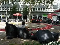 Bild von Menschen die auf einem Platz sitzen und Lesen