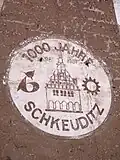 Teil einer alten Außenwerbung der VEB Edelpelz „1000 Jahre Schkeuditz“ (Aufnahme von 2005)