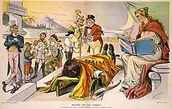»Waiting for the verdict - the coroner's jury will undoubtedly find that the deceased committed suicide«, Puck (1898) Karikatur, die Uncle Sam zusammen mit John Bull und den Personifikationen von Deutschland, Italien, Russland, Österreich und Frankreich zeigt, wie sie am Sterbebett Spaniens diskutieren. Auf dem Messer nahe der Hand Spaniens steht »Dummheit«. Die Personifikation der Geschichte blickt finster, bereit, das Urteil niederzuschreiben.