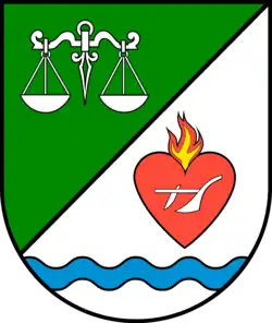 Wappen der Ortschaft Schartau (Schräglinksgeteilt vorn in Grün eine silberne Waage, hinten in Silber über gesenktem blauen Wellenbalken ein rotes brennendes Herz belegt mit einem silbernen Pflug)