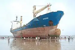 Das gestrandete Schiff als lokale Attraktion bei Niedrigwasser.